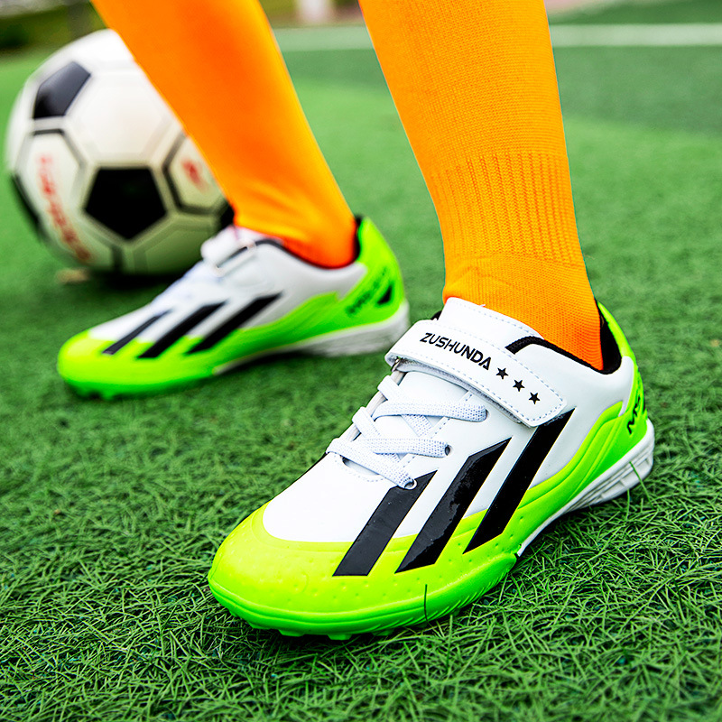 Factory direct selling children's football shoes tf broken nails artificial lawn boys and girls students leather feet students training sneakers