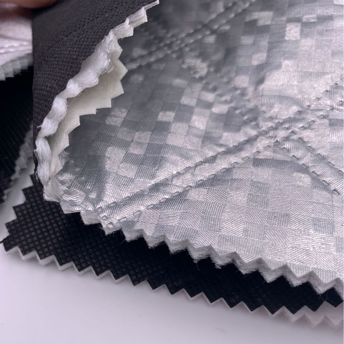 In stock snow shield fabric aluminum film car clothing fabric ultrasonic composite non-woven three-in-one embossed embossed cotton fabric