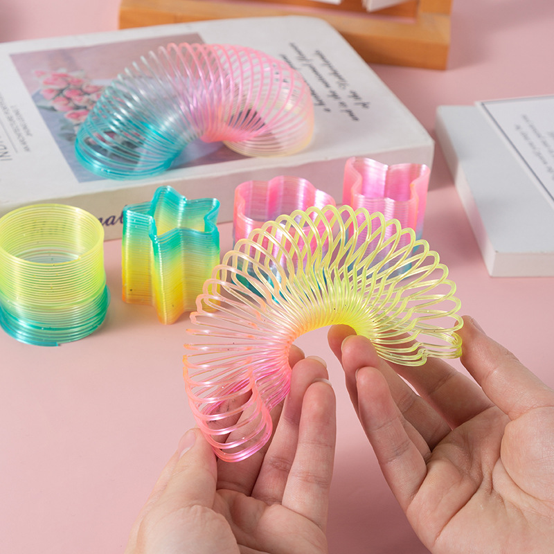 Heart-shaped magic rainbow ring plastic spring ring rainbow stacking music classic educational children's toy stall wholesale