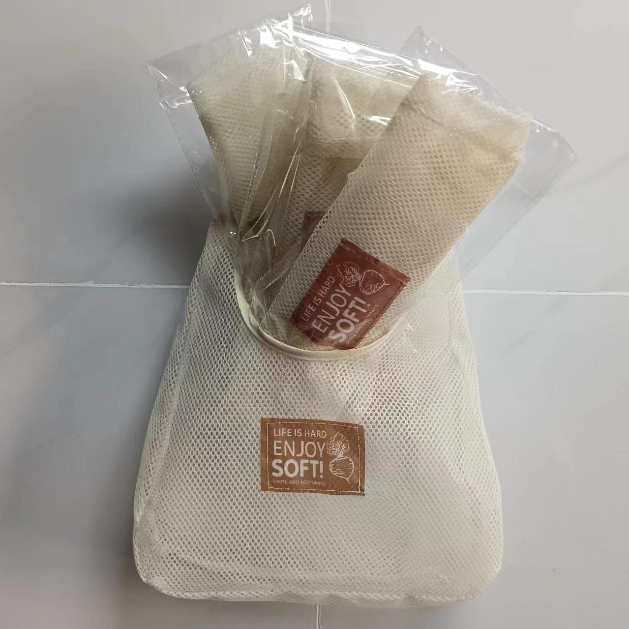 Home wall-mounted creamy-white storage hanging bag for ginger, garlic and onion hollow breathable storage bag wholesale