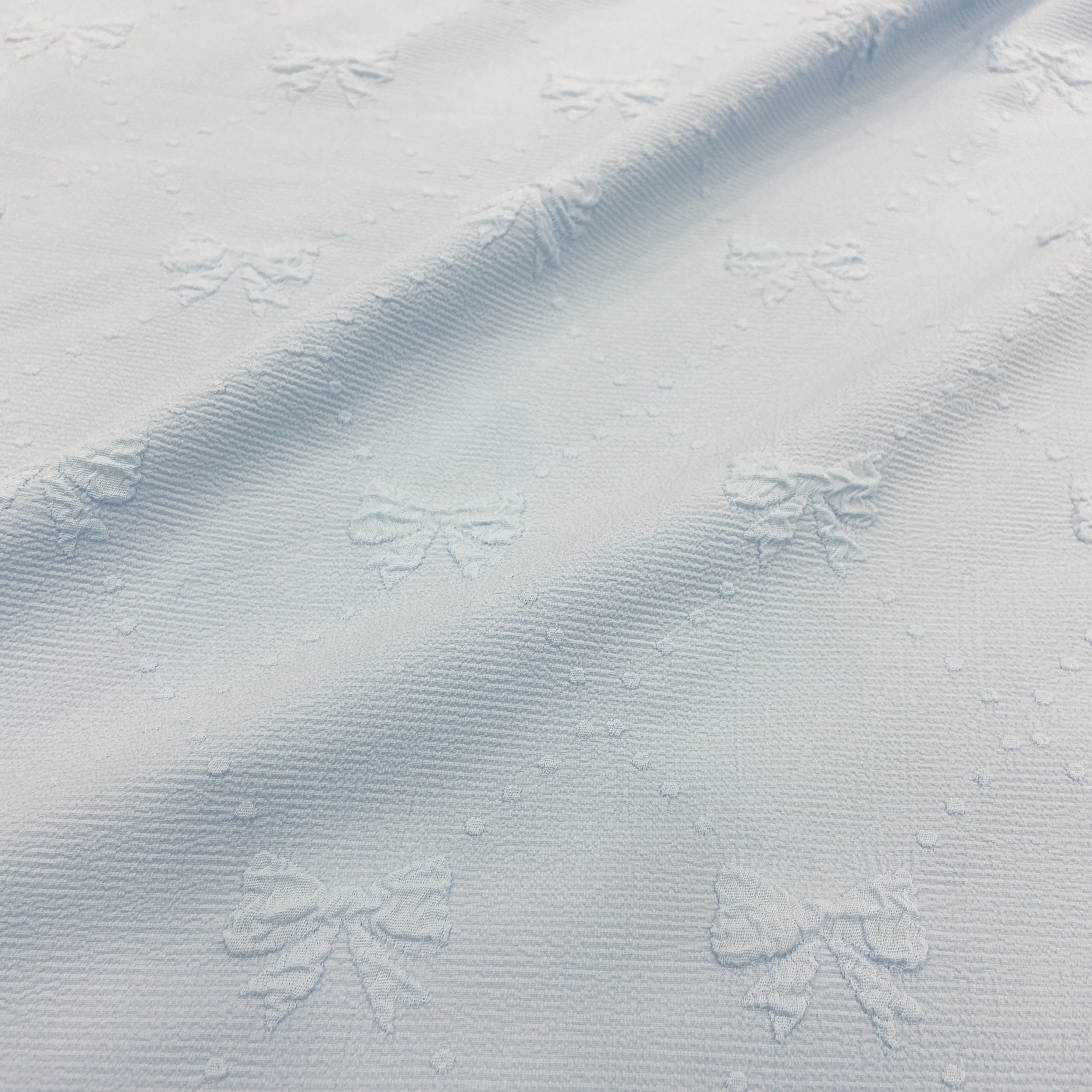 Spot four-sided bubble embossed small Bow Jacquard fashion women's clothing children's dress small top fabric