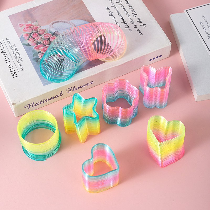 Heart-shaped magic rainbow ring plastic spring ring rainbow stacking music classic educational children's toy stall wholesale